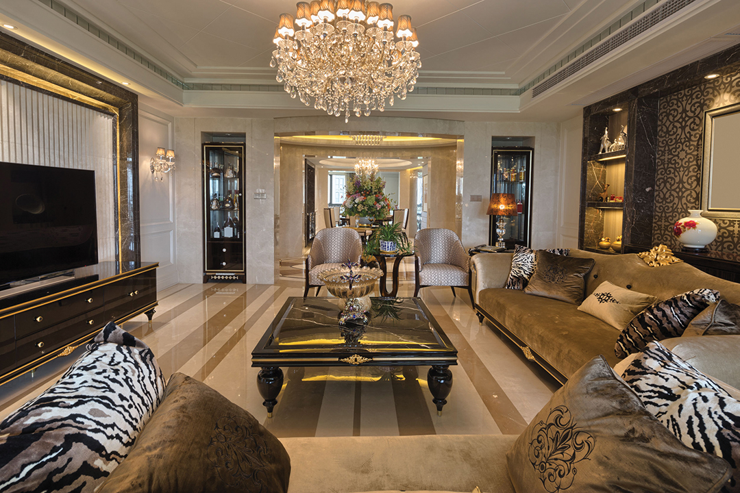 Luxury living room interior fixed in golds and browns with a crystal chandelier