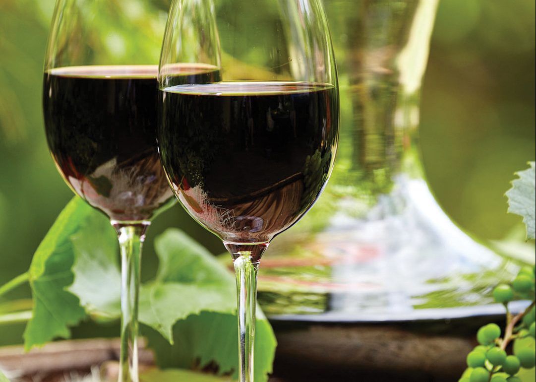 old wooden barrel with glass of red wine