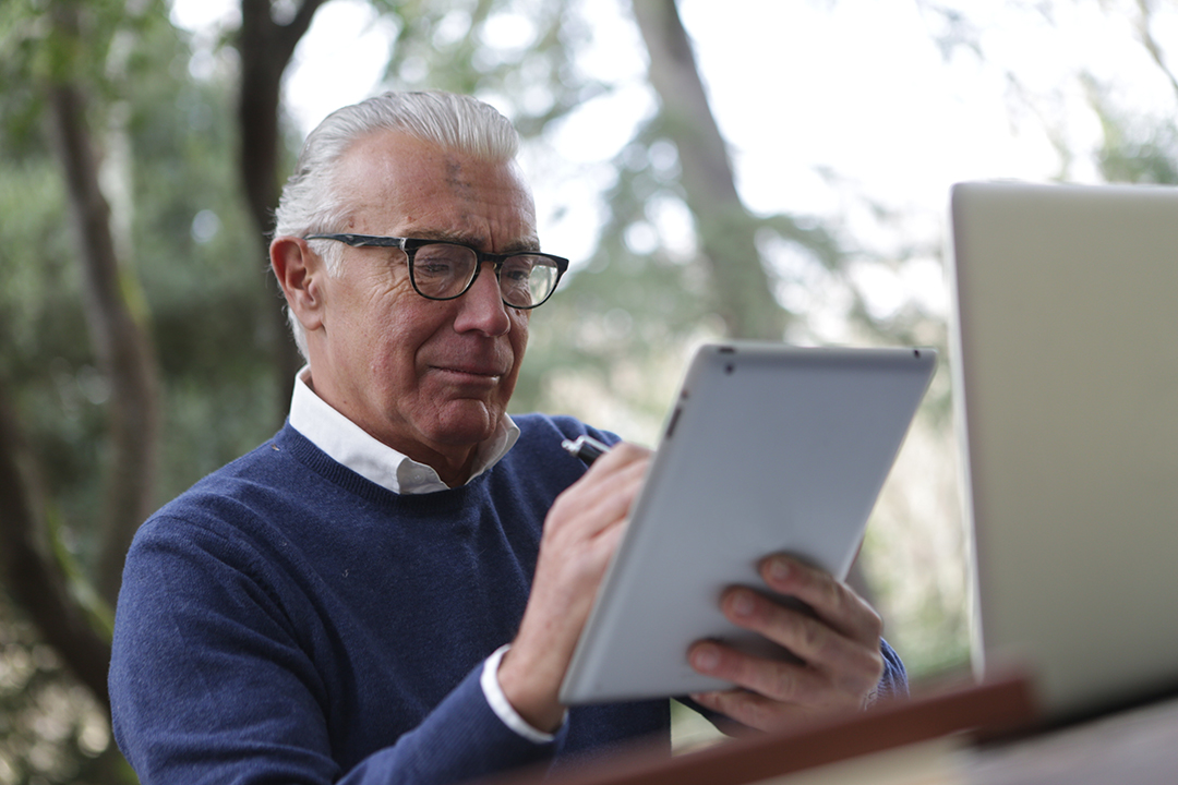 Older gentleman using tablet