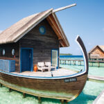 At Como Cocoa Island, overwater villas resemble the gently curving wooden vessels used by local fishermen
