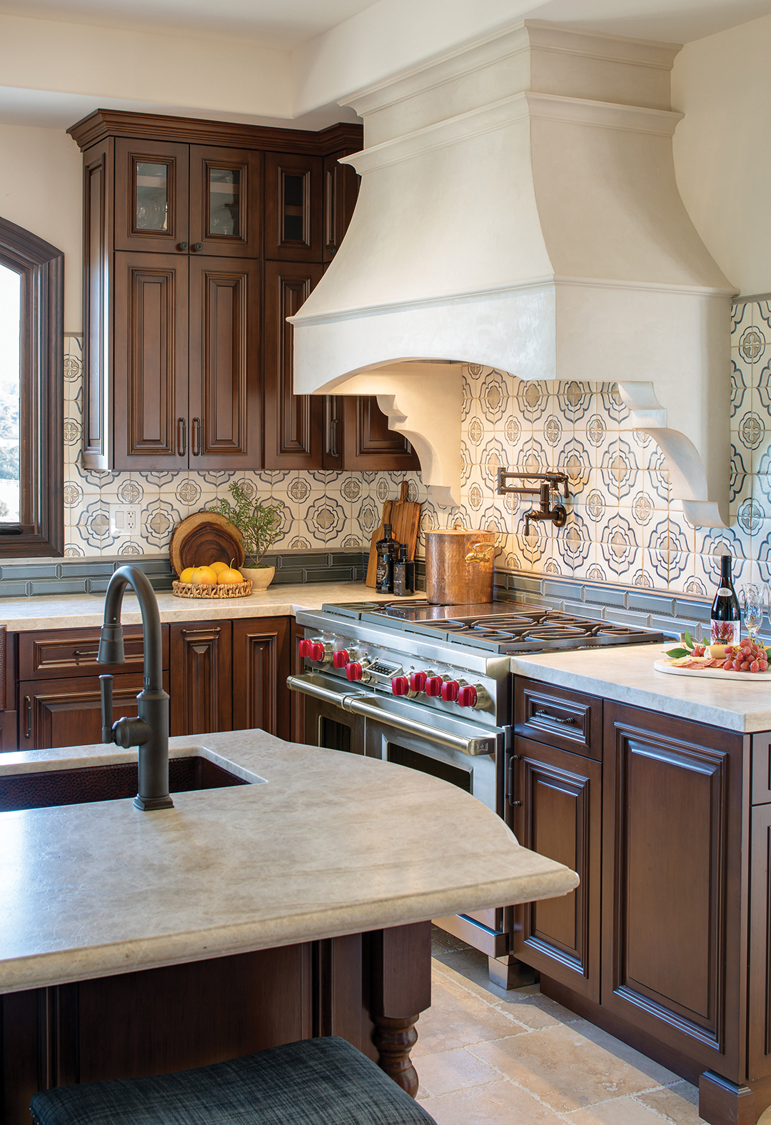 Counters are in honed Taj Mahal quartzite with a backsplash of hand-painted terra cotta tiles