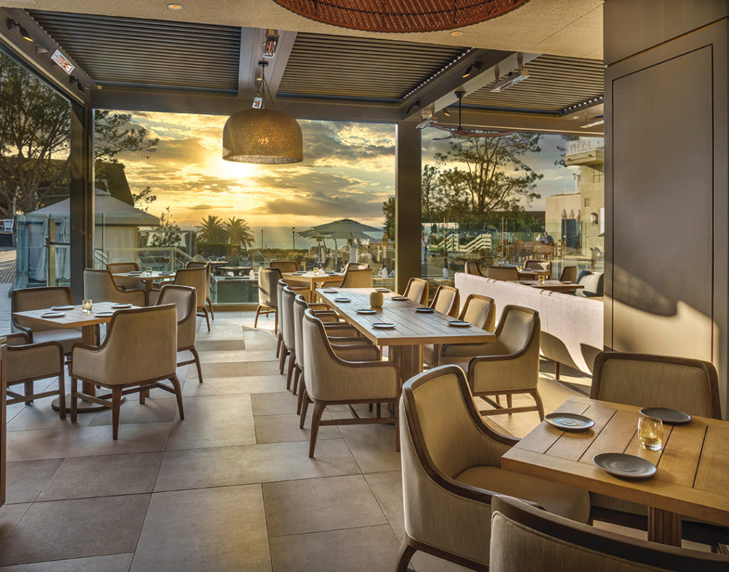The large doors of Adelaide’s dining room that open to the outdoors take full advantage of L’Auberge’s ocean views
