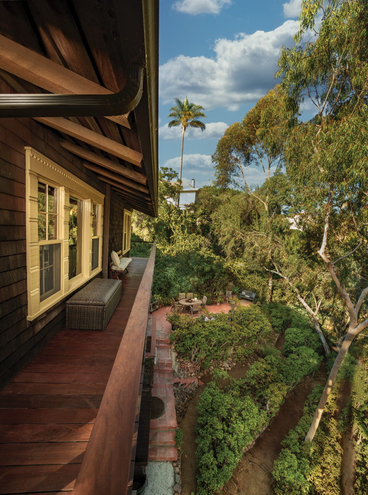 A wraparound deck offers views of the canyon below, landscaped with eucalyptus trees and rows of jade plants