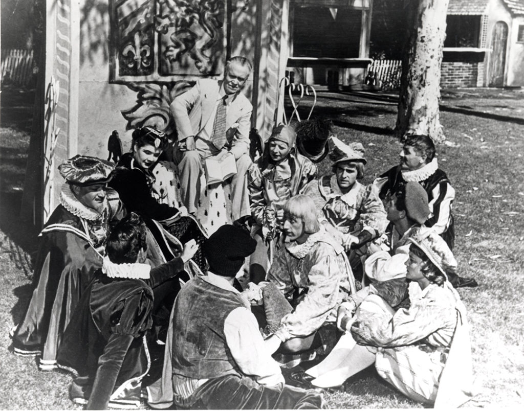 Famed stage director and teacher B. Iden Payne with members of the Old Globe Theatre's 1949 Shakespeare Festival company on the greensward fronting the famed San Diego landmark