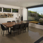The sleek dining area offers dazzling views