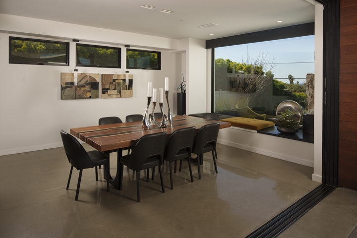 The sleek dining area offers dazzling views