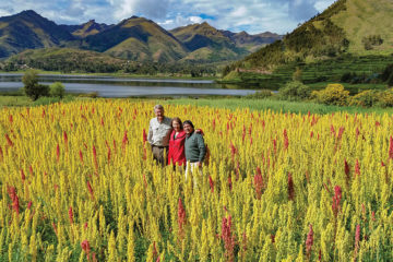 The author, her husband, and their guide in a field of red quinoa in Peru