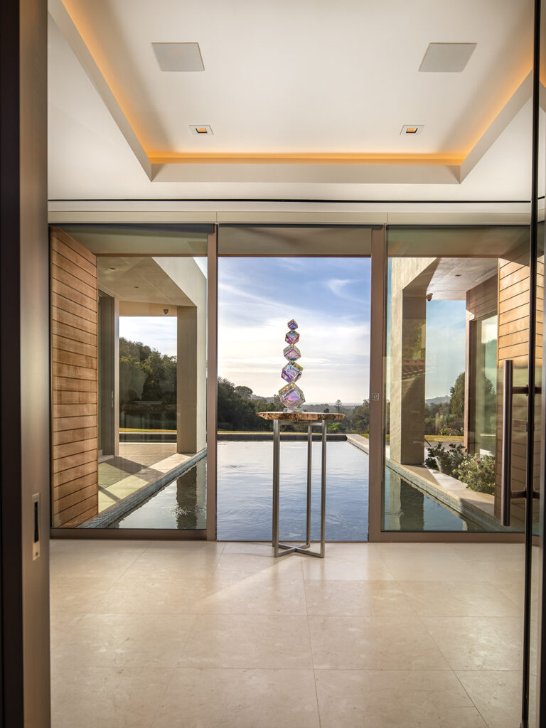 A striking sculpture in the foyer overlooks a reflecting pool, with the Cardiff coastline in the distance