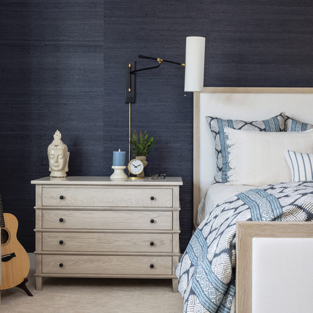 The design team splurged on the master suite, adding grasscloth walls and a custom headboard and linens