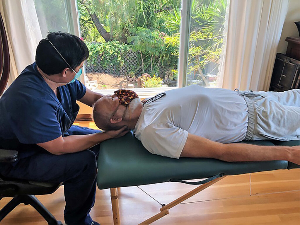 Michael Kuris, Doctor of Osteopathic Medicine and founder of Measured Wellness, works with a patient on his road to a balanced and healthy lifestyle