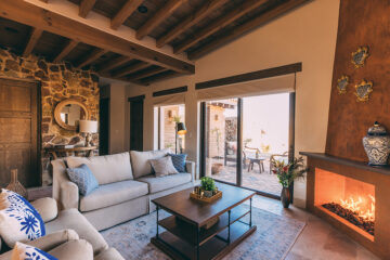 Spacious living and dining areas with fireplaces open onto covered outdoor patios