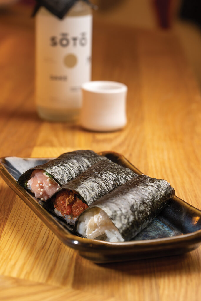 Three-piece hand roll set of yellowtail, spicy tuna, 
and scallops paired with Soto, Super Premium Junmai Daiginjo sake