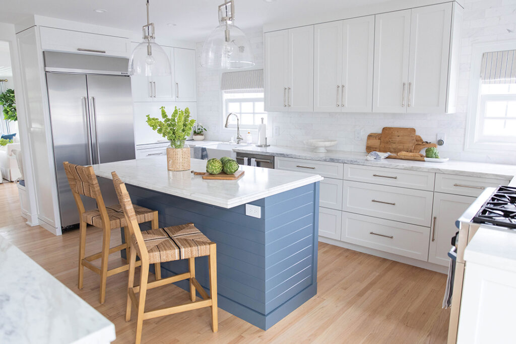 The kitchen includes DC Custom Cabinets, an Amazon Stones island and marble counters, appliances from Pirch, and Cabochon faucets. The original oak floors were sanded and stained
