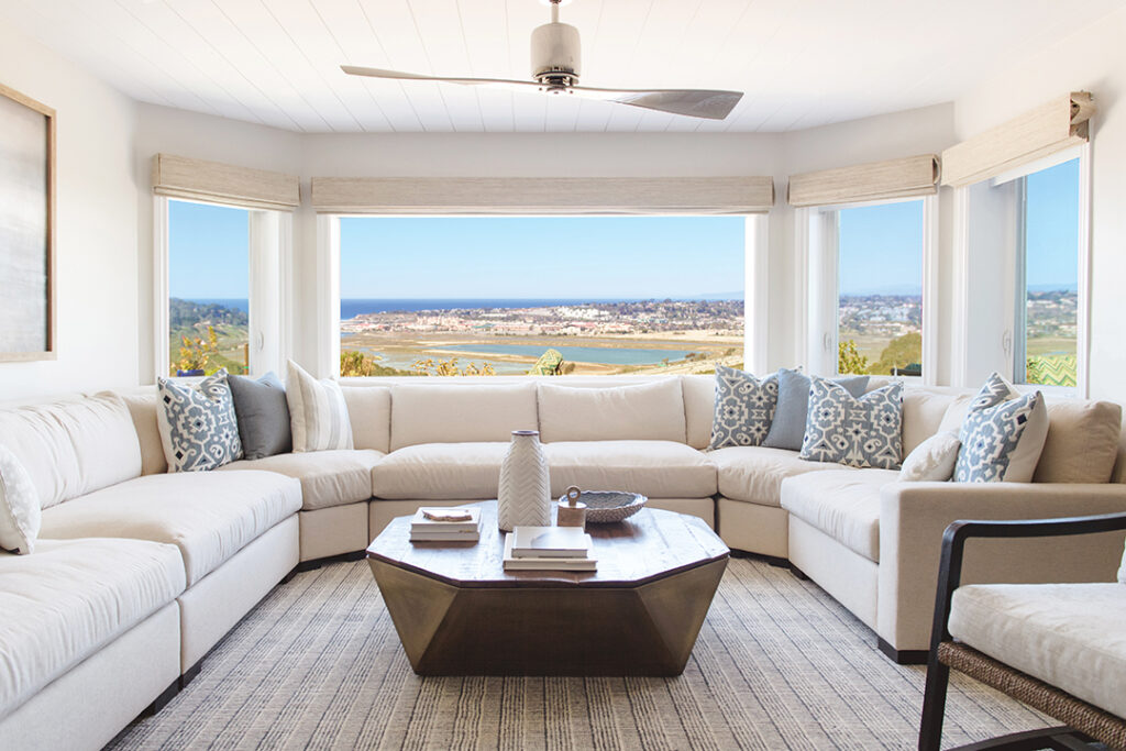 Designed by Savvy Interiors, the Mohr living room, with its sweeping view of the Del Mar coast and racetrack, features a custom sectional by inSIDE by Savvy