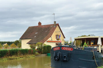 Adrienne eases past the lock keeper’s cottage after locking through at Fontaines-sur-Saône in Eastern France