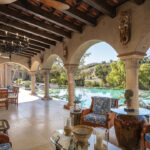 The infinity-edge swimming pool off the outdoor living room overlooks the rolling hills of Rancho Santa Fe