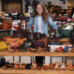 “Sole Sister” Stephanie Stock surrounded by shoes at Cedros Soles, the business that has been in her family for nearly two decades
