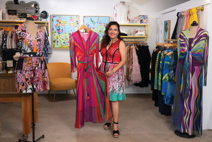 Roya Parviz, wearing a brightly patterned dress by Renee’ Dehry, shows off a colorful design at Satori Collective in the Cedros Design District