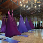 A popular class is aerial yoga, in which guests, wrapped in silky “cocoons” suspended from the ceiling, are guided through gentle yoga poses