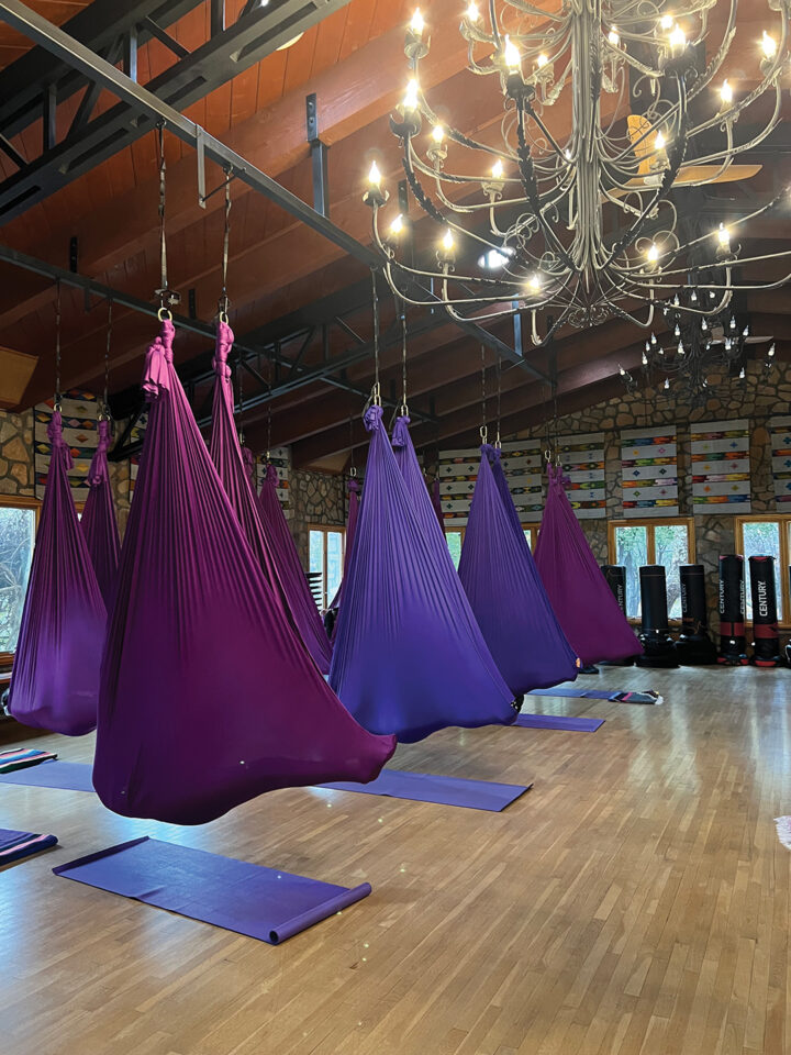 A popular class is aerial yoga, in which guests, wrapped in silky “cocoons” suspended from the ceiling, are guided through gentle yoga poses