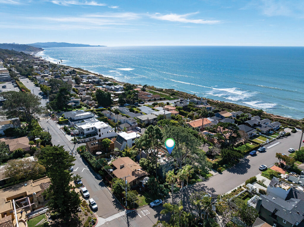 An aerial view depicts the abundance of trees around the house