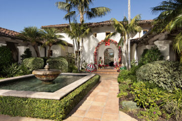 At the Rancho Santa Fe home of Ted Hoehn and partner Matt Clermont, the festive arch over the front door and decorations were designed with the help of Kimberly Buffington of Flowerchild