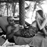 Kelly and his partner, Kalani Miller, share a moment on Tavarua in Fiji