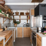 The kitchen was designed with the help of a chef friend to optimize its ergonomics. Custom-built with concrete and raw wood, it blends professional-grade equipment with a warm aesthetic, including a butcher block sourced from an old Bayonne butcher shop