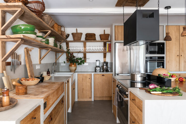 The kitchen was designed with the help of a chef friend to optimize its ergonomics. Custom-built with concrete and raw wood, it blends professional-grade equipment with a warm aesthetic, including a butcher block sourced from an old Bayonne butcher shop