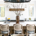 The kitchen and family room feature lighting by Rejuvenation and Essentials for Living bar stools with Perennials fabric. The island is Silestone Zeus White Suede finish and perimeter counters are Absolute Black Honed granite. Range and refrigerator are by Thermador