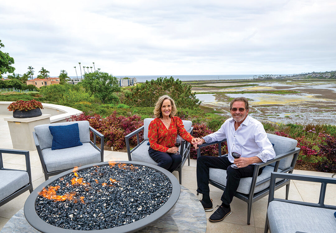 Philly and Ron Montbleau gather around the fire bowl they designed as a gathering space for after-dinner conversation. The fire bowl is crafted of Fusion quartzite from Arizona Tile and fabricated by American Marble. Arizona Tile was also used in the hardscape by Geoff Herbert