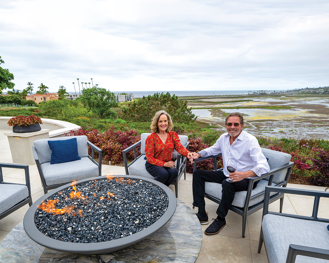 Philly and Ron Montbleau gather around the fire bowl they designed as a gathering space for after-dinner conversation. The fire bowl is crafted of Fusion quartzite from Arizona Tile and fabricated by American Marble. Arizona Tile was also used in the hardscape by Geoff Herbert