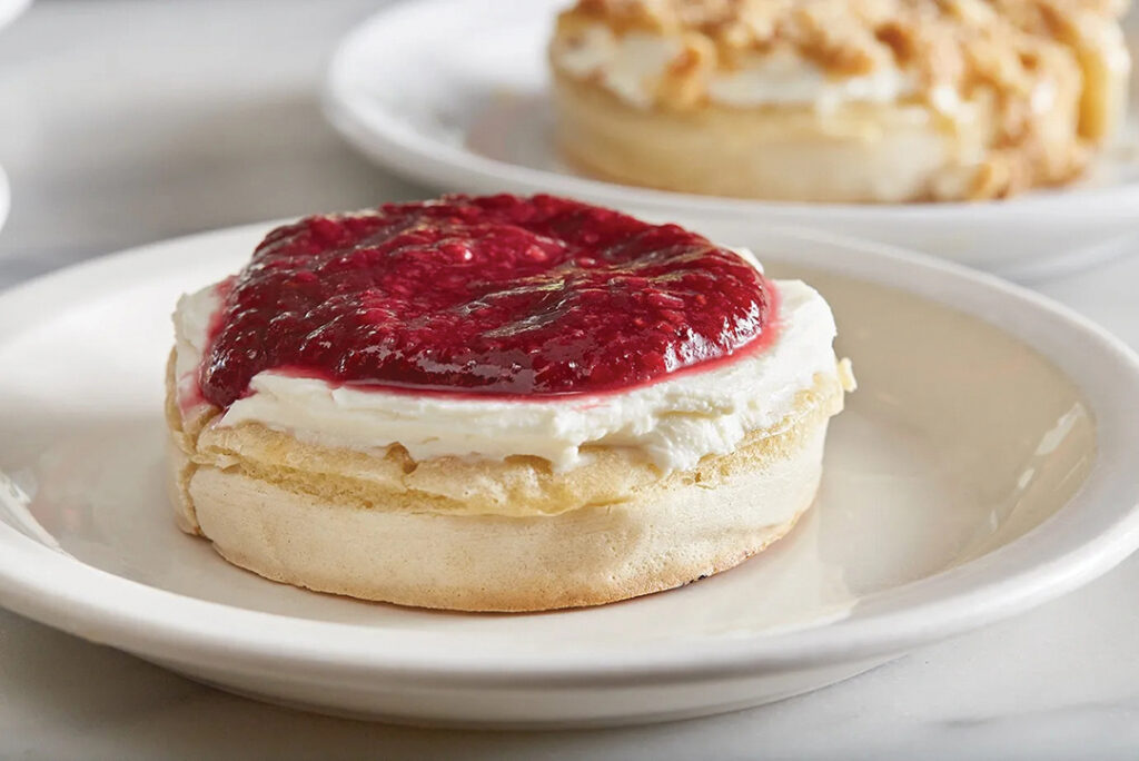 Fresh crumpet topped with ricotta and strawberry preserves at The Crumpet Shop