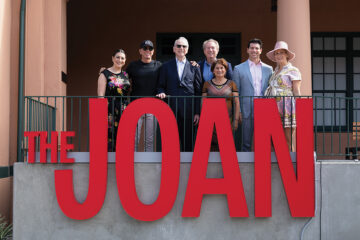 Philanthropist Irwin Jacobs, surrounded by family members, at the ribbon cutting ceremony for the Joan and Irwin Jacobs Performing Arts Center, nicknamed “The Joan”