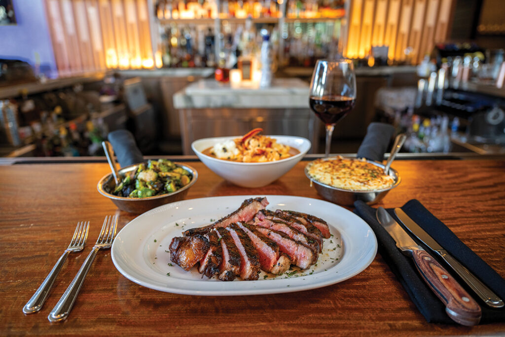 Bone-In Ribeye 22oz, Roasted Brussels Sprouts, Lobster Mashed Potatoes, and White Cheddar Mac & Cheese