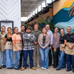 Mia’s management team (back row, center, L-R) Henry Staunton, Scott Buchan, and Annia Bonifaz, with staff