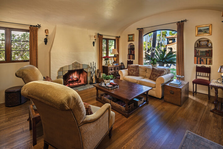 In the cozy living room, the couple’s favorite feature is the original 1929 Calco tile fireplace with a Mayan theme. The tile colors provided inspiration for the room’s decor
