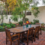 The couple spend much of their time on the expansive brick patio, centered with a fireplace for relaxing and entertaining