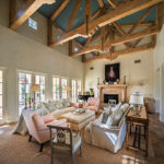 The airy living room opens onto a patio and swimming pool and features a mix of modern pieces, antiques, and flea market finds