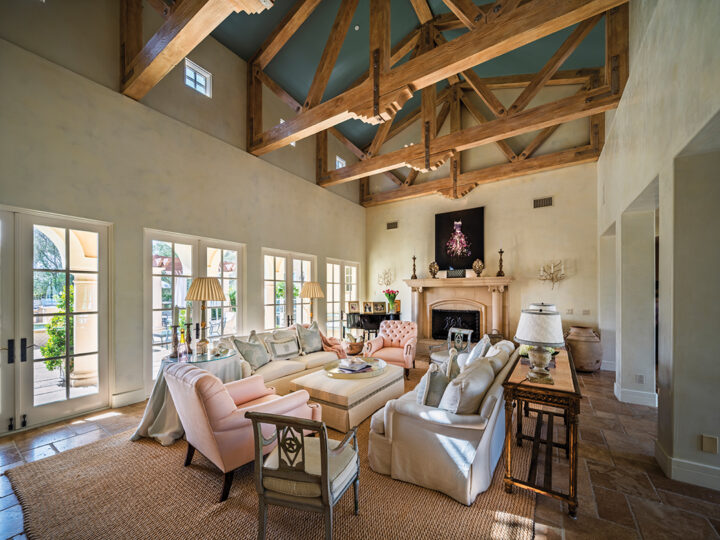 The airy living room opens onto a patio and swimming pool and features a mix of modern pieces, antiques, and flea market finds