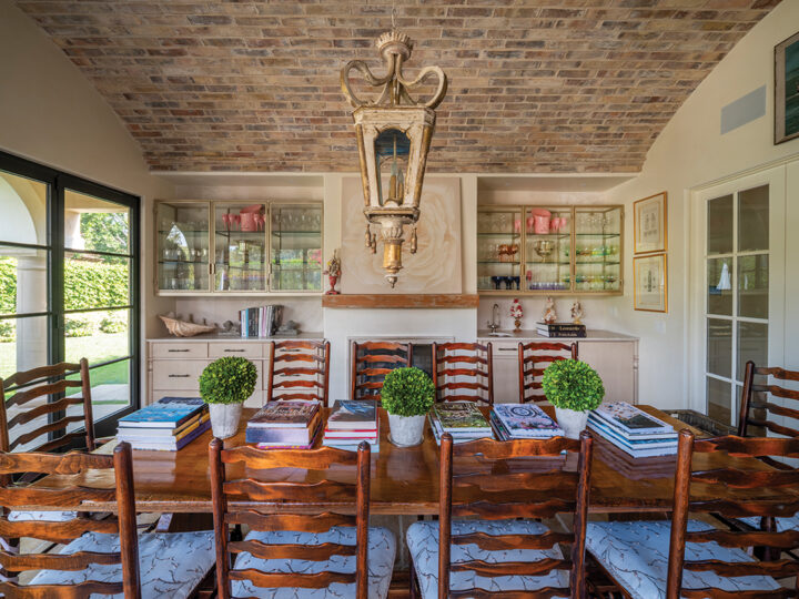 The home’s dining-reading room opens onto a patio with a firepit. The ceiling, centered with an antique chandelier, is set with old bricks from France