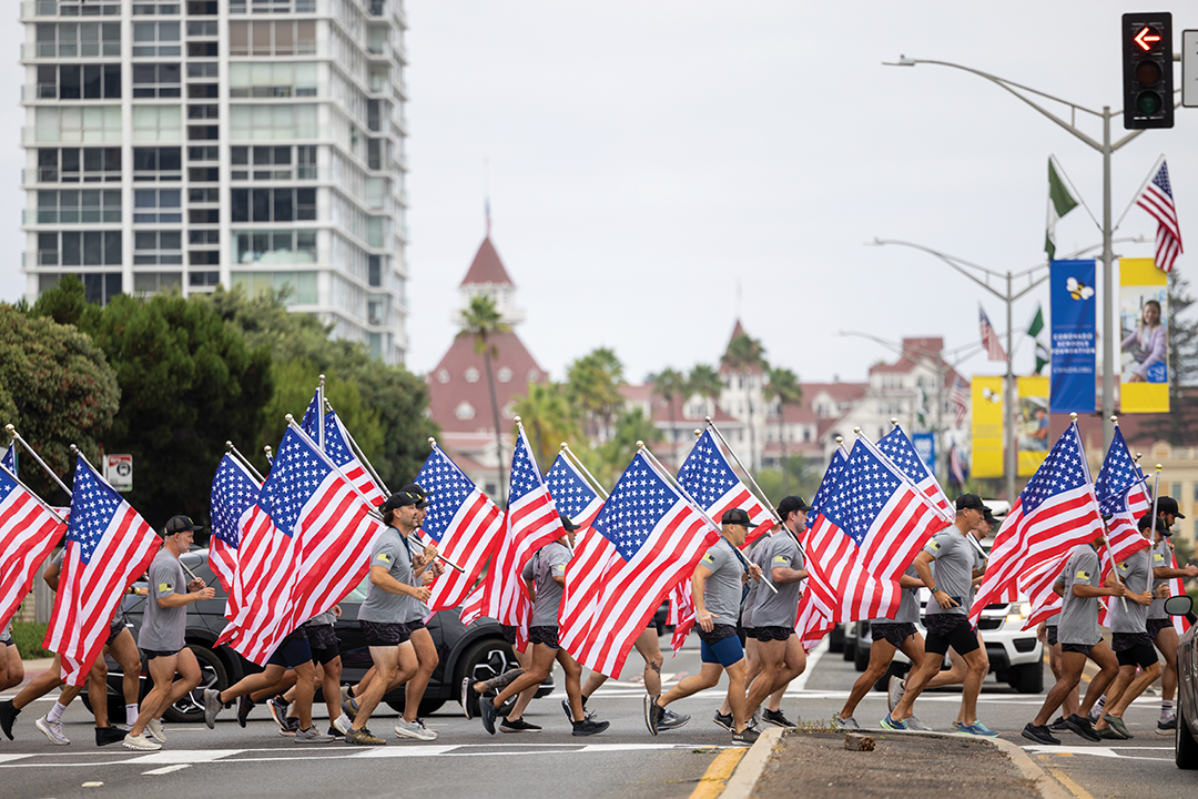 Participants running to Glorietta Bay for the start of the 2025 Swim for SOF event