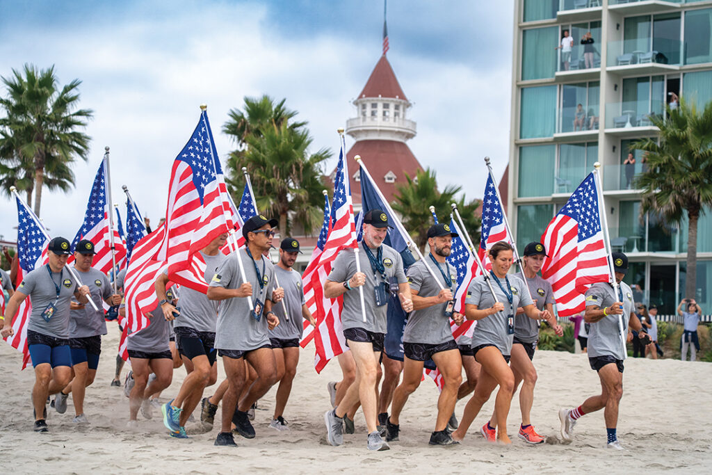 Participants running to Glorietta Bay for the start of the 2025 Swim for SOF event