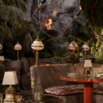 It’s the blue lagoon reimagined as Night Hawk, an open-fire Greek restaurant. Rock-formed booths and banquettes create nooks from which to review the overwrought design