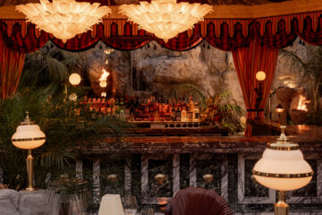 It’s the blue lagoon reimagined as Night Hawk, an open-fire Greek restaurant. Rock-formed booths and banquettes create nooks from which to review the overwrought design