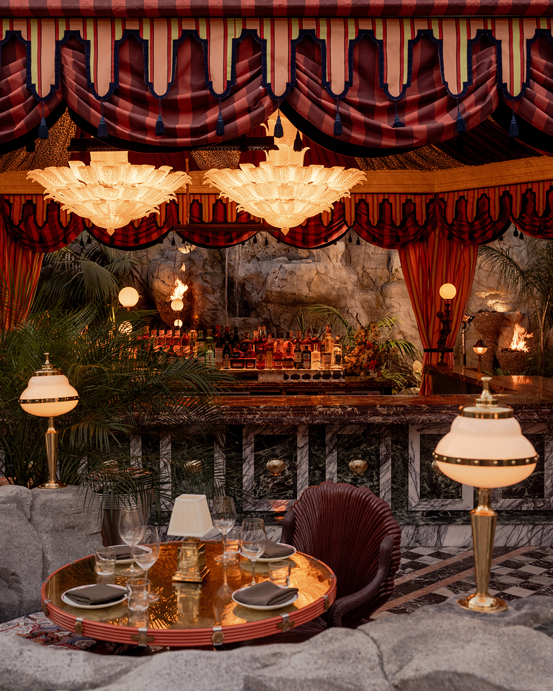 It’s the blue lagoon reimagined as Night Hawk, an open-fire Greek restaurant. Rock-formed booths and banquettes create nooks from which to review the overwrought design