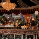 It’s the blue lagoon reimagined as Night Hawk, an open-fire Greek restaurant. Rock-formed booths and banquettes create nooks from which to review the overwrought design