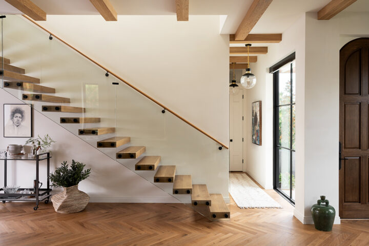 The floating staircase makes a striking architectural gesture and is a quiet canvas for one of Lovell’s treasured pieces, a sketch of Jimi Hendrix. A bold purple office offsets Lovell’s collection of photo memories