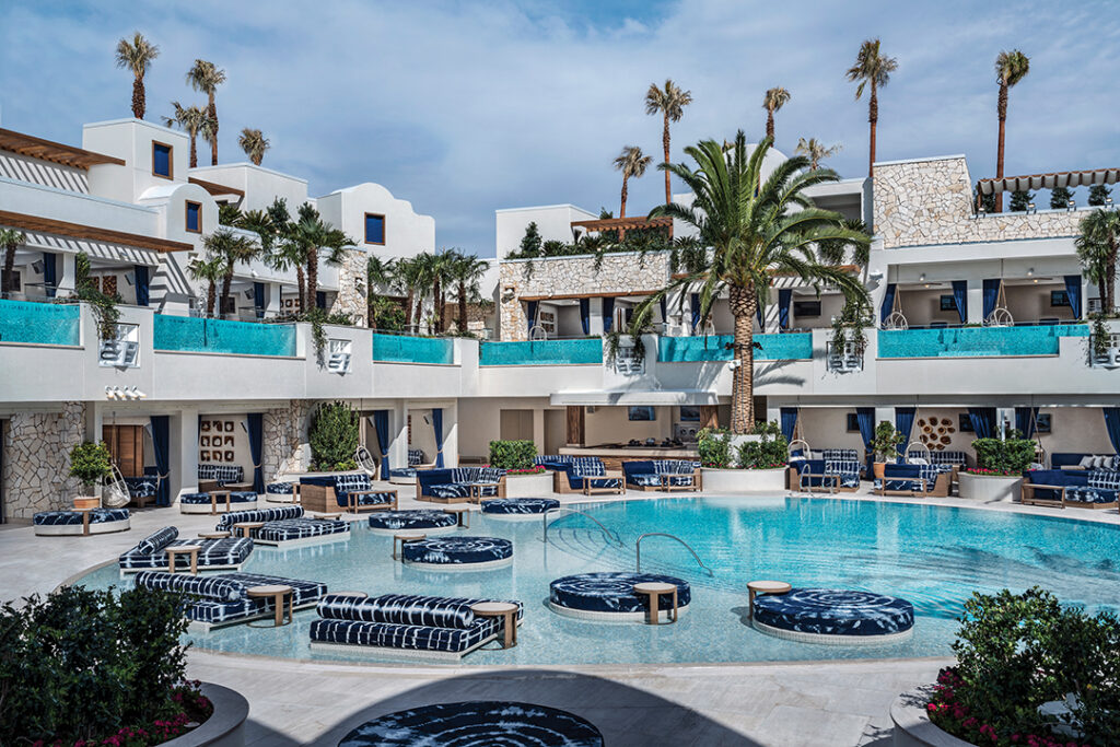Palms Pool invites guests to unwind in style with spacious cabanas, private bungalows, and island daybeds