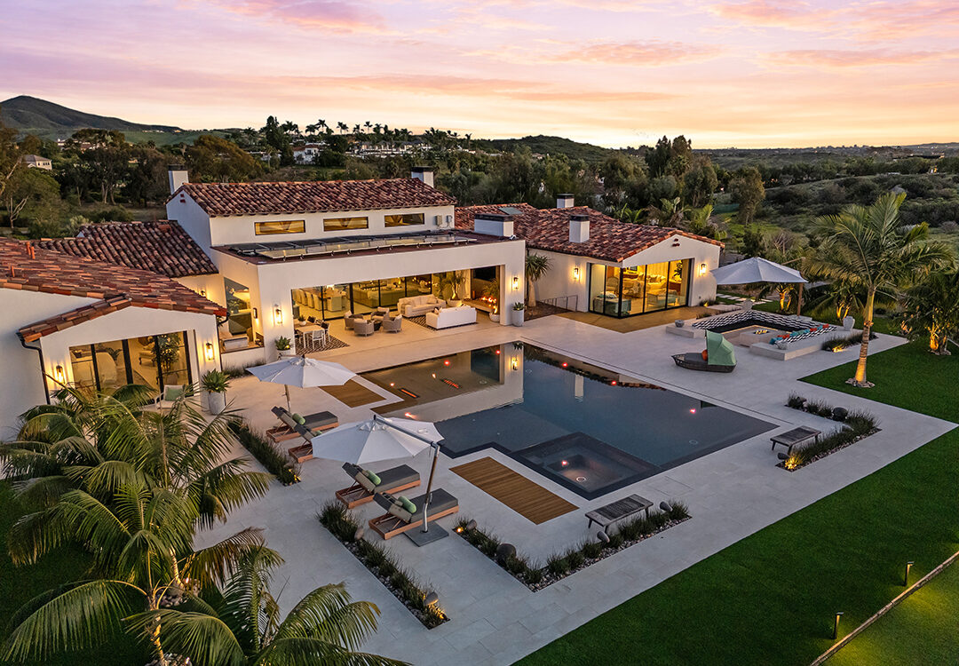 Set on a 2.62-acre lot, this 7,014-square-foot estate on 16786-88 Calle Hermosa in Rancho Santa Fe features 6 bedrooms, 8 bathrooms, a 5-car garage, and a 2-bedroom guest house. It is listed for $9,850,000